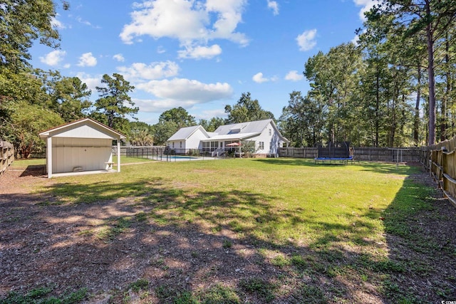 62 Warbler St, Georgetown, SC 29440 - fenced backyard featuring a trampoline