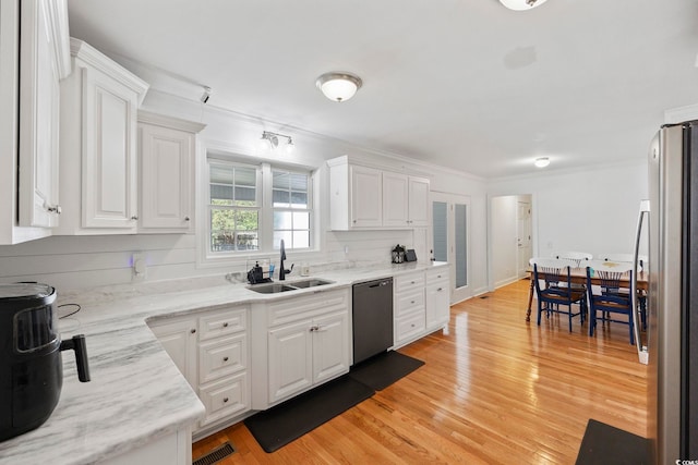 62 Warbler St, Georgetown, SC 29440 - kitchen featuring stainless steel appliances, white cabinets, crown molding, light wood-style floors, and light stone countertops