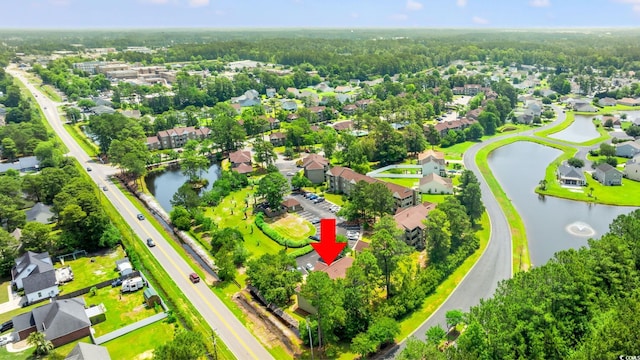 aerial perspective of suburban area with a nearby body of water