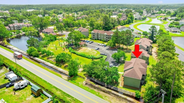 aerial view of residential area featuring a nearby body of water