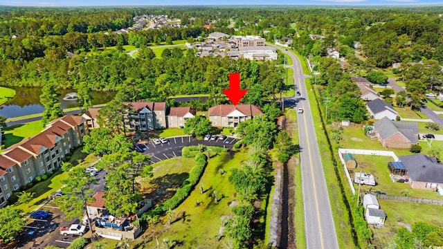 view of property location featuring a nearby body of water and nearby suburban area