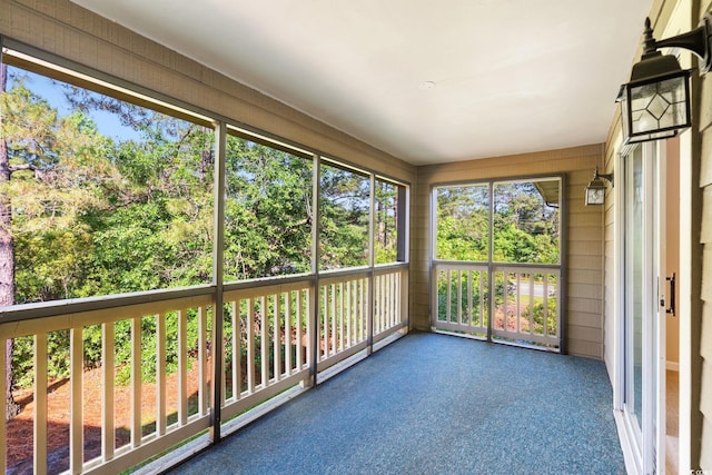 unfurnished sunroom featuring carpet