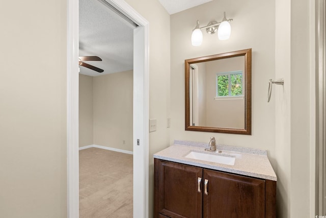 bathroom with vanity, ceiling fan, and baseboards