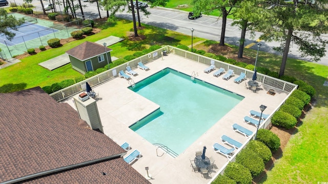 community pool featuring fence and a patio
