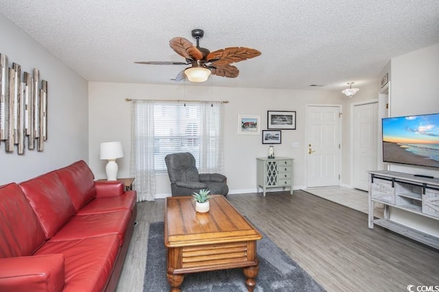 404 1st Ave N Unit H, North Myrtle Beach, SC 29582 - living room with a textured ceiling, wood finished floors, a ceiling fan, and baseboards