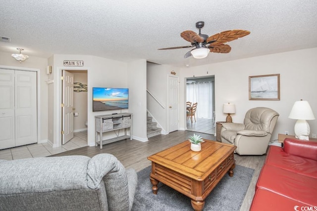 404 1st Ave N Unit H, North Myrtle Beach, SC 29582 - living area featuring a ceiling fan, a textured ceiling, stairs, baseboards, and wood finished floors