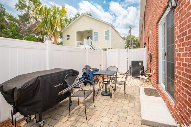 404 1st Ave N Unit H, North Myrtle Beach, SC 29582 - fenced backyard featuring central AC, outdoor dining area, and a patio area