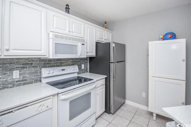 404 1st Ave N Unit H, North Myrtle Beach, SC 29582 - kitchen featuring white appliances, light countertops, white cabinetry, decorative backsplash, and light tile patterned floors