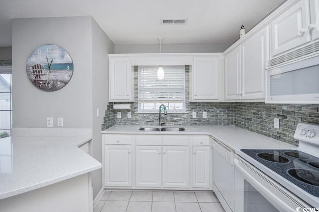 404 1st Ave N Unit H, North Myrtle Beach, SC 29582 - kitchen with white appliances, a sink, light tile patterned floors, and plenty of natural light