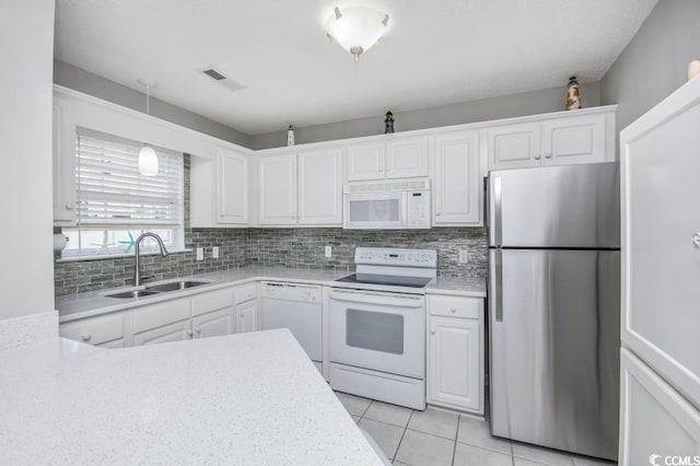 404 1st Ave N Unit H, North Myrtle Beach, SC 29582 - kitchen featuring white appliances, a sink, white cabinets, and light countertops