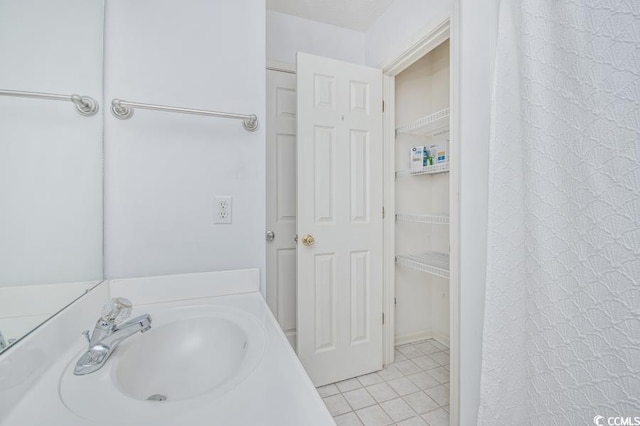 404 1st Ave N Unit H, North Myrtle Beach, SC 29582 - bathroom featuring tile patterned flooring, vanity, and a closet