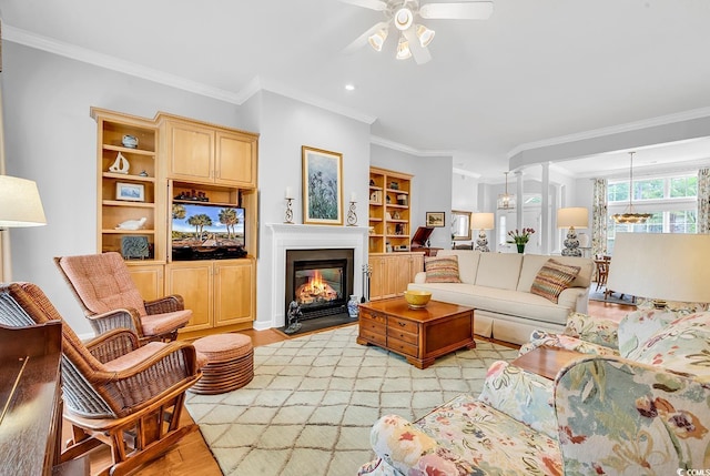 67 Camden Cir, Pawleys Island, SC 29585 - living area featuring a ceiling fan, crown molding, light wood-style flooring, a multi sided fireplace, and recessed lighting