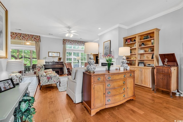 living area with light wood-style floors, ceiling fan, ornamental molding, and recessed lighting