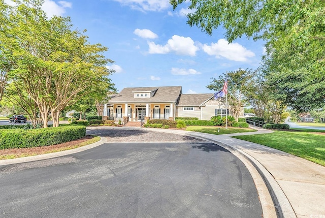 67 Camden Cir, Pawleys Island, SC 29585 - view of front of property featuring a porch, curved driveway, and a front lawn
