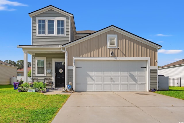 348 Hidden Cove Dr, Little River, SC 29566 - view of front of house featuring a front lawn, a garage, driveway, and covered porch