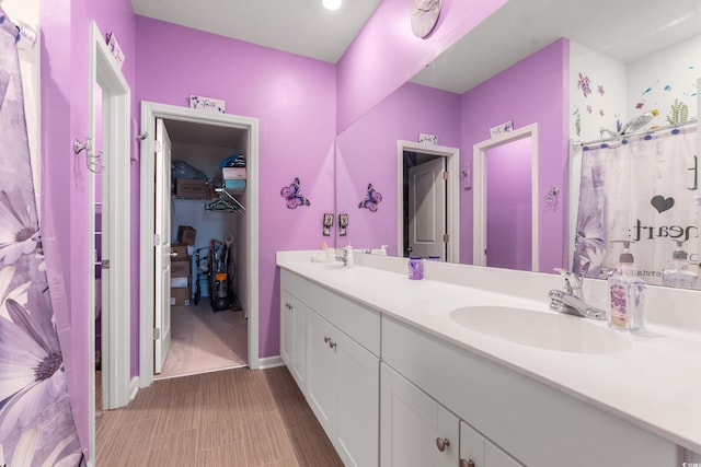 348 Hidden Cove Dr, Little River, SC 29566 - bathroom featuring double vanity, a spacious closet, and baseboards