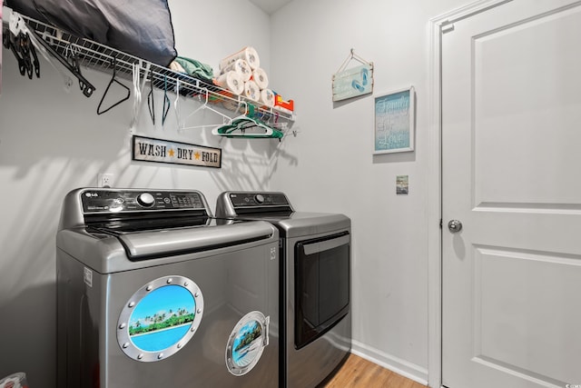 348 Hidden Cove Dr, Little River, SC 29566 - laundry area featuring separate washer and dryer, wood finished floors, and baseboards