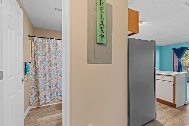 510 Fairwood Lakes Dr Unit 19-Q, Myrtle Beach, SC 29588 - hall featuring light wood-type flooring, a textured ceiling, baseboards, and electric panel