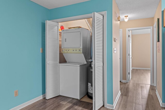 510 Fairwood Lakes Dr Unit 19-Q, Myrtle Beach, SC 29588 - washroom with stacked washing machine and dryer, wood finished floors, and baseboards