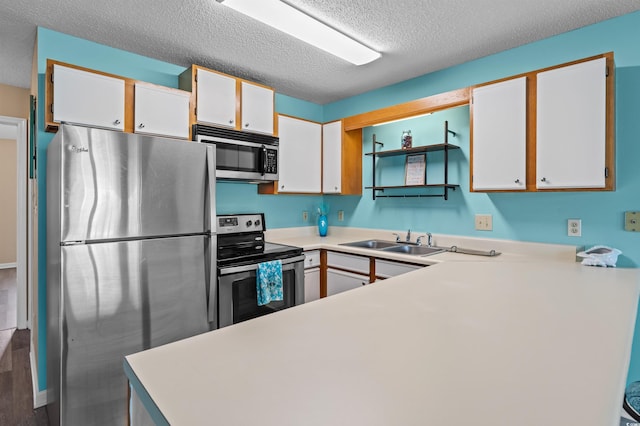 510 Fairwood Lakes Dr Unit 19-Q, Myrtle Beach, SC 29588 - kitchen featuring stainless steel appliances, a sink, a textured ceiling, light countertops, and white cabinetry