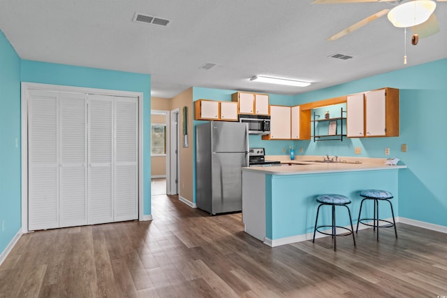 510 Fairwood Lakes Dr Unit 19-Q, Myrtle Beach, SC 29588 - kitchen featuring stainless steel appliances, dark wood finished floors, baseboards, and a textured ceiling