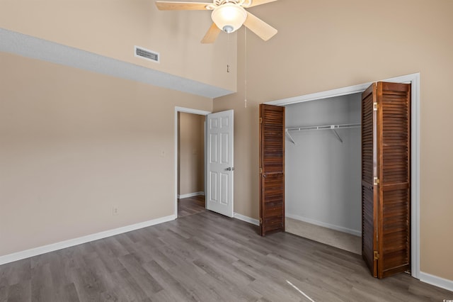 510 Fairwood Lakes Dr Unit 19-Q, Myrtle Beach, SC 29588 - unfurnished bedroom with a high ceiling, a closet, wood finished floors, baseboards, and a ceiling fan