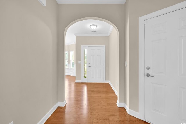 644 Harbor Bay Dr, Murrells Inlet, SC 29576 - foyer entrance with arched walkways, crown molding, light wood-type flooring, and baseboards