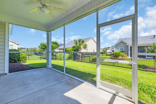 644 Harbor Bay Dr, Murrells Inlet, SC 29576 - unfurnished sunroom featuring a residential view and a ceiling fan