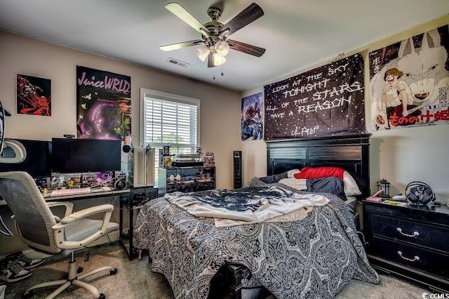 carpeted bedroom with a desk and ceiling fan