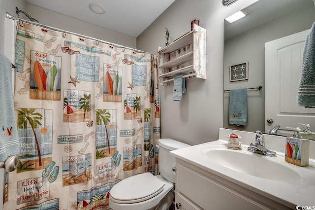 bathroom with toilet, vanity, and a shower with curtain