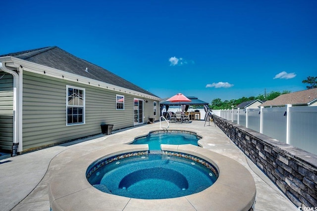 view of pool with a gazebo, a patio, a fenced backyard, and a pool with connected hot tub