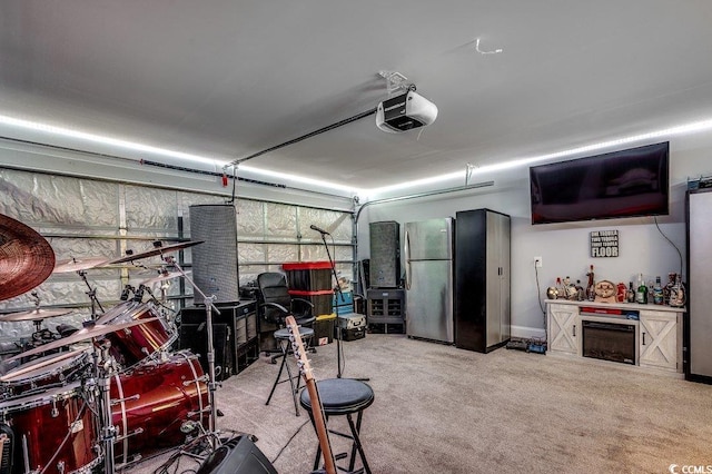 garage featuring freestanding refrigerator and a garage door opener