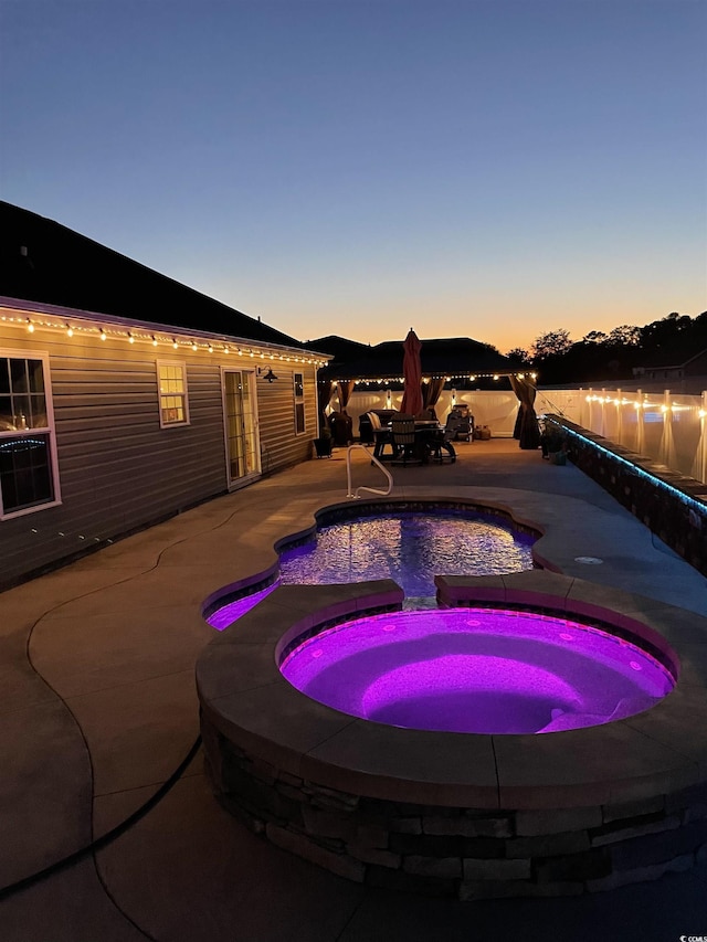 view of swimming pool with an in-ground hot tub and a patio area