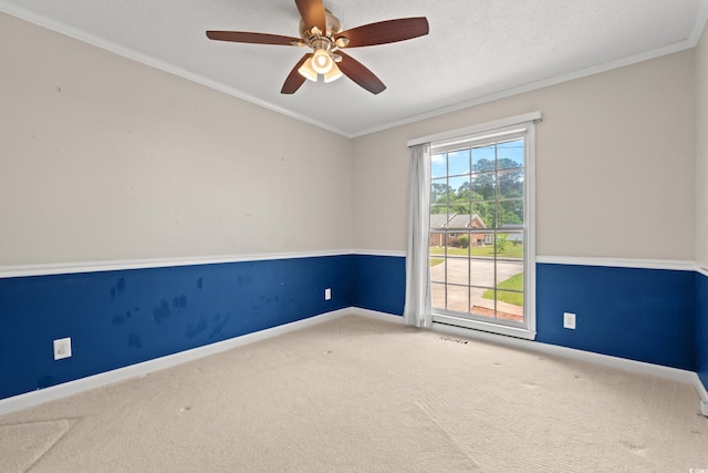 unfurnished room featuring carpet floors, baseboards, a ceiling fan, crown molding, and a textured ceiling