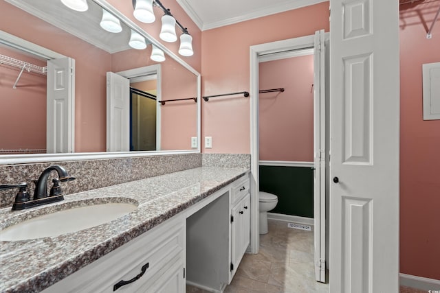 full bath with toilet, ornamental molding, vanity, a spacious closet, and marble finish floors