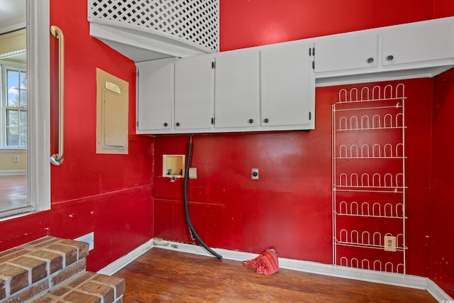 laundry area with washer hookup, cabinet space, wood finished floors, baseboards, and hookup for an electric dryer