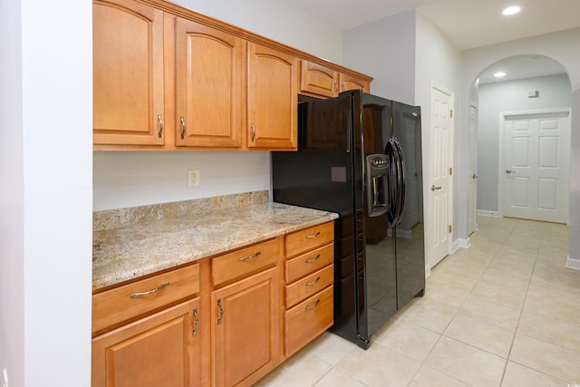 249 Ashepoo Creek Dr, Myrtle Beach, SC 29579 - kitchen with black fridge with ice dispenser, arched walkways, light stone counters, light tile patterned flooring, and recessed lighting