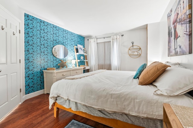 5523 N Ocean Blvd Unit 1903, Myrtle Beach, SC 29577 - bedroom with wallpapered walls, an accent wall, wood finished floors, and baseboards