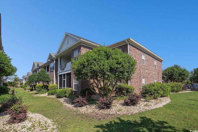 2029 Silvercrest Dr Unit 22B, Myrtle Beach, SC 29579 - view of side of property featuring brick siding and a yard