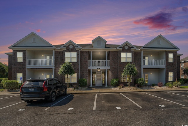 2029 Silvercrest Dr Unit 22B, Myrtle Beach, SC 29579 - view of front of home featuring brick siding, uncovered parking, and a balcony