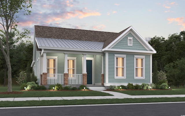 812 Maltby Aly, Myrtle Beach, SC 29588 - view of front of home with covered porch, a metal roof, a front lawn, and a standing seam roof