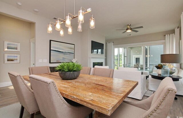 812 Maltby Aly, Myrtle Beach, SC 29588 - dining space with wood finished floors, a ceiling fan, and a fireplace