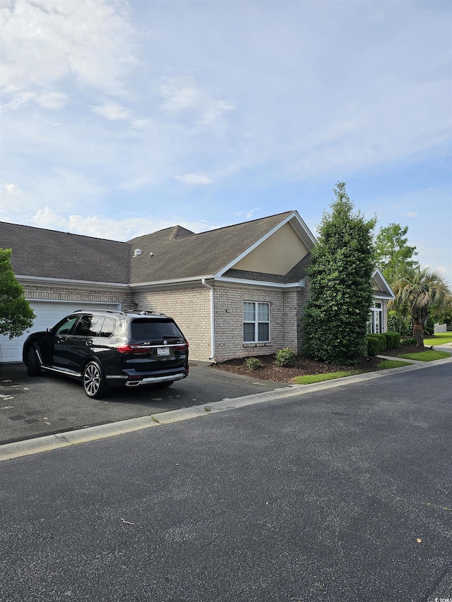 1426 Saint Thomas Cir Unit A 3, Myrtle Beach, SC 29577 - view of front of house with asphalt driveway, an attached garage, and brick siding