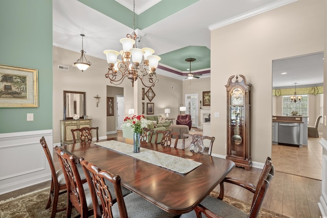 dining room featuring a chandelier, crown molding, hardwood / wood-style floors, and ceiling fan