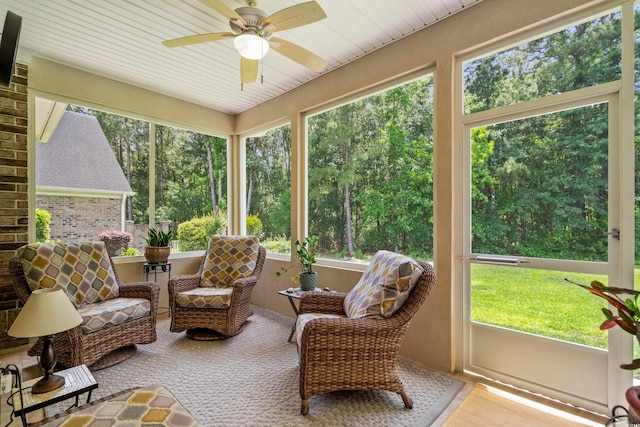 sunroom / solarium with a ceiling fan and plenty of natural light
