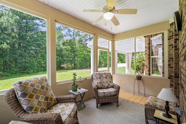 sunroom with ceiling fan and plenty of natural light