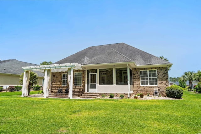 rear view of house with brick siding, a pergola, a yard, and a sunroom