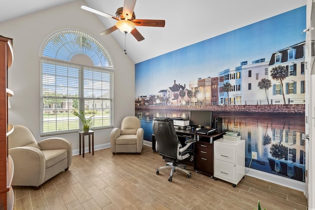 office space with vaulted ceiling, ceiling fan, light wood-style floors, and baseboards