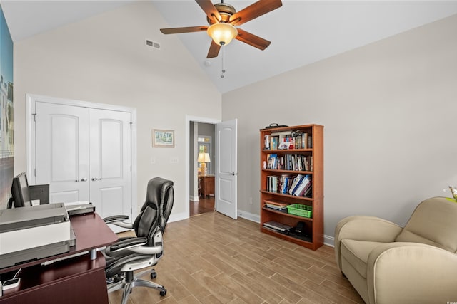 office space with high vaulted ceiling, ceiling fan, baseboards, and light wood finished floors