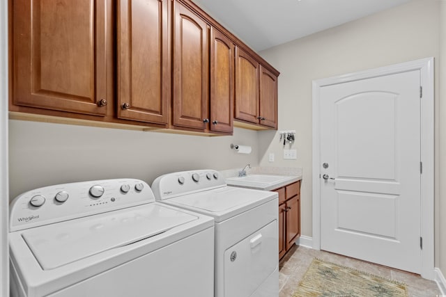 laundry area featuring cabinet space, washer and dryer, light tile patterned floors, and baseboards